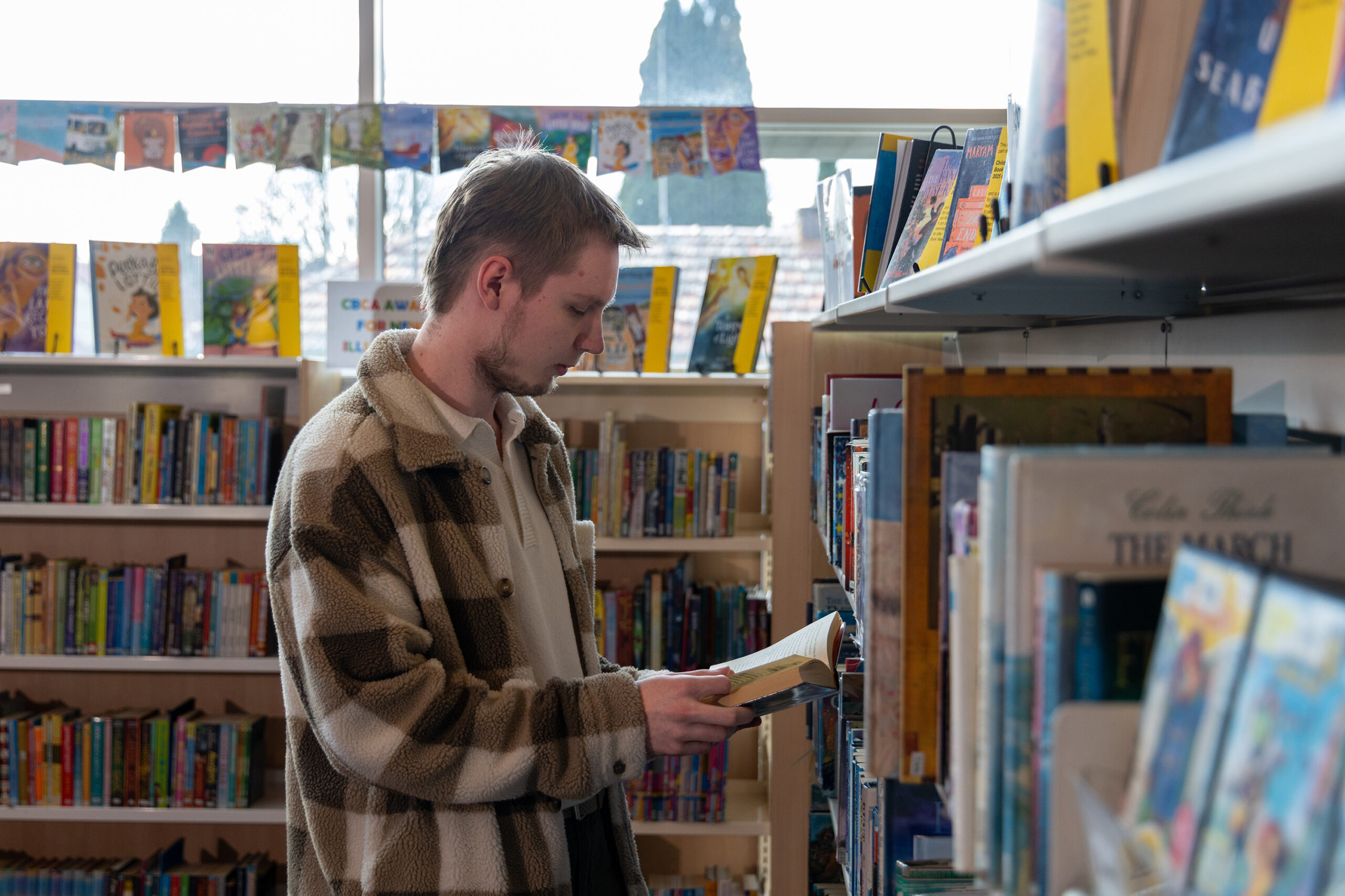 young man readying book atTHE BOWRAL CITY LIBRARY