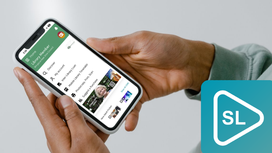Person holding a phone with Spydus Library open.