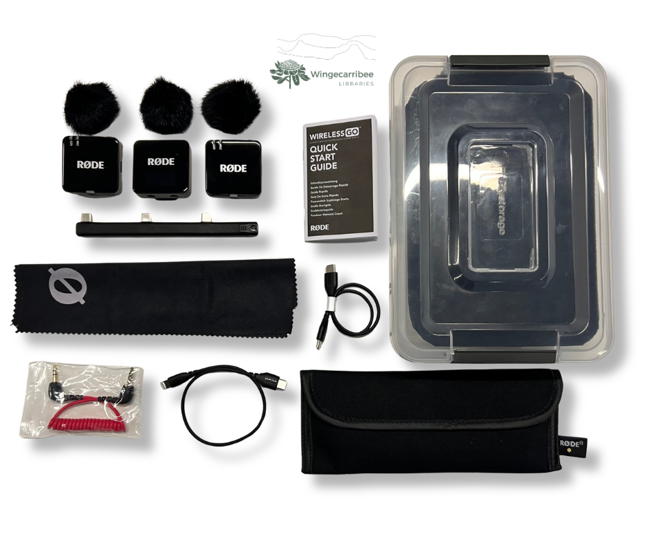 The wireless microphone kit sits on a white table with all contents laid out.