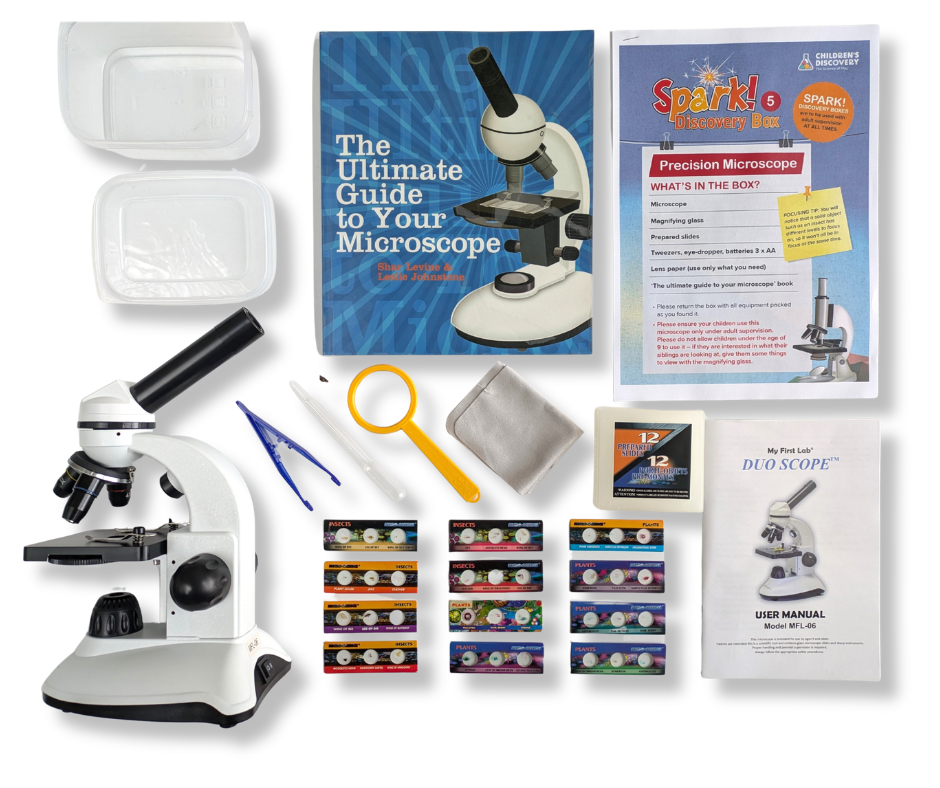 Precision Microscope kit contents laid out on a white table.